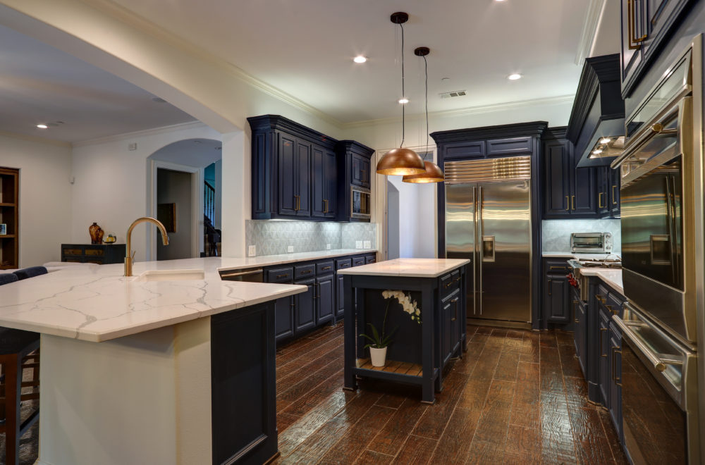 Modern Kitchen with Dark Wood Floor and Dark Blue Cabinets and White Countertop