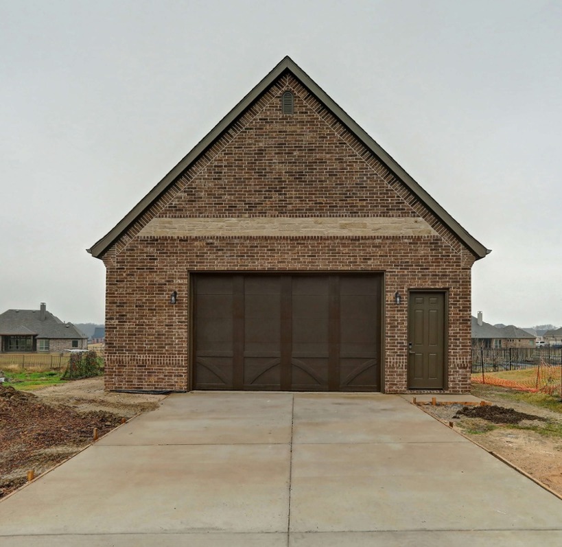 Dallas remodeled garage with brown brick and brown doors